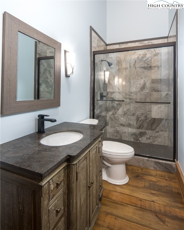 708 Goldenrod Road Boone, NC 28607 - Photo 23 of 49 a bathroom with a granite countertop sink toilet a mirror and shower