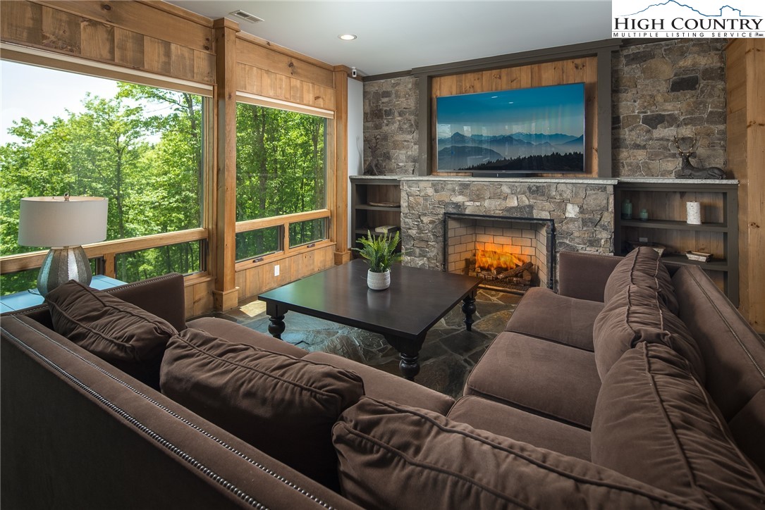 708 Goldenrod Road Boone, NC 28607 - Photo 29 of 49 a living room with furniture a flat screen tv and a fireplace