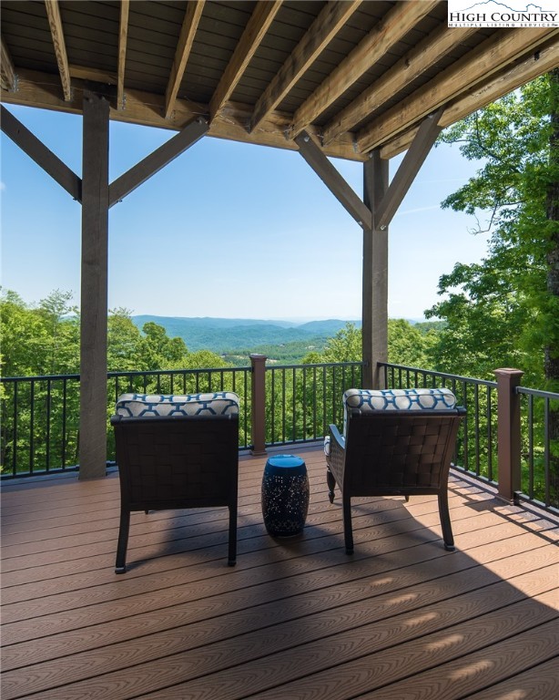 708 Goldenrod Road Boone, NC 28607 - Photo 33 of 49 a view of a roof deck with table and chairs potted plants with wooden floor and fence