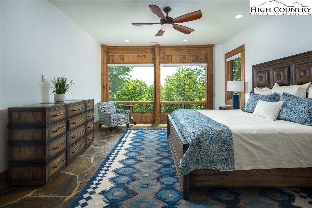 708 Goldenrod Road Boone, NC 28607 - Photo 35 of 49 a bedroom with a bed and large windows