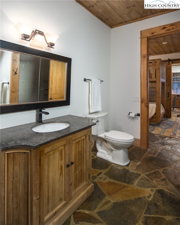 708 Goldenrod Road Boone, NC 28607 - Photo 41 of 49 a bathroom with a granite countertop sink toilet and mirror