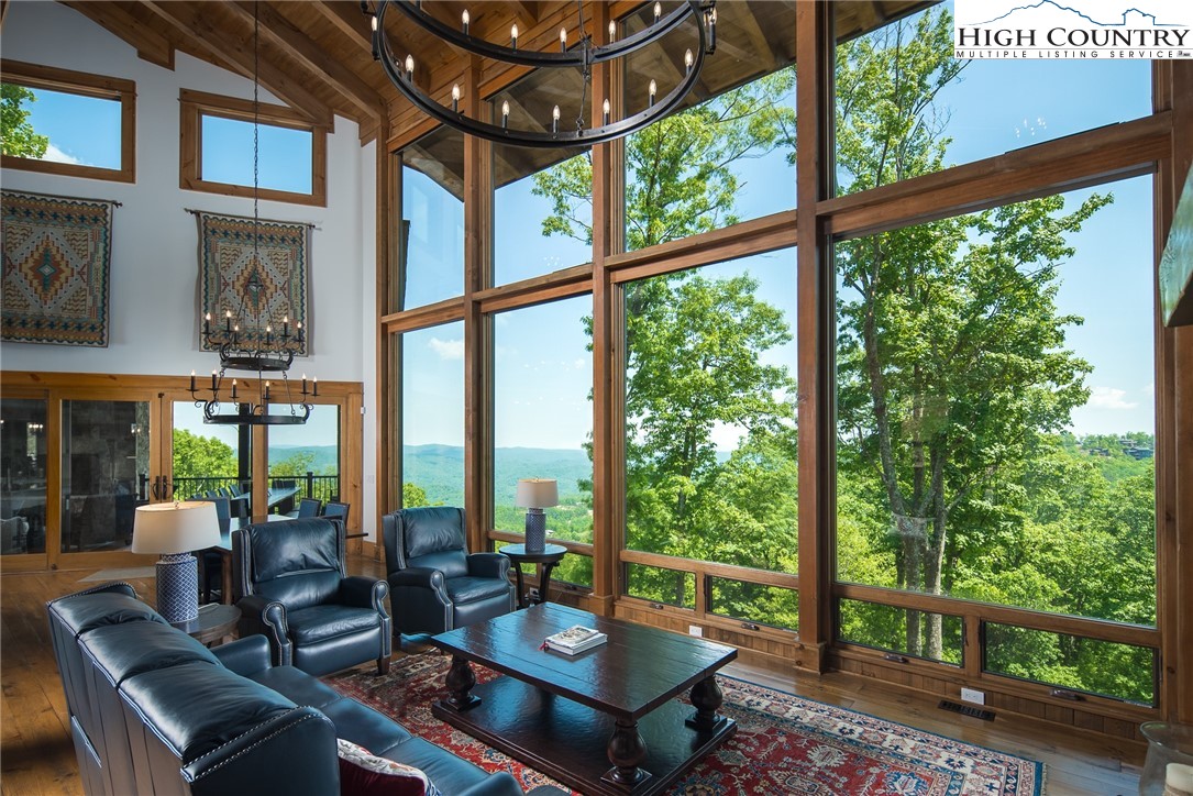 708 Goldenrod Road Boone, NC 28607 - Photo 5 of 49 a living room with large windows and wooden floor