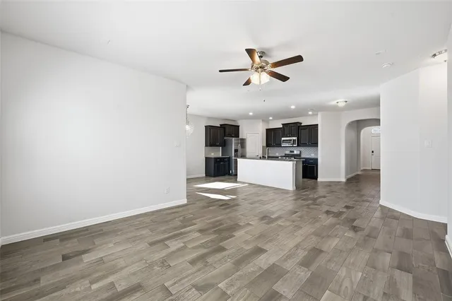 a view of a kitchen with a sink and refrigerator