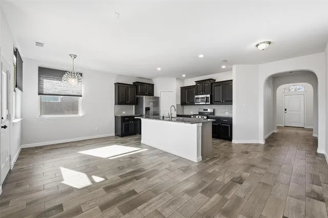 a large kitchen with cabinets and stainless steel appliances