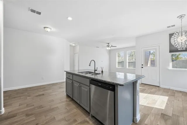 a kitchen with granite countertop a sink and cabinets