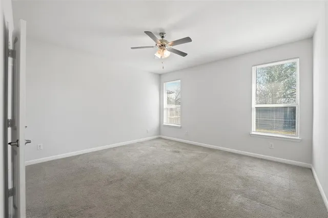 a view of a livingroom with a ceiling fan and window