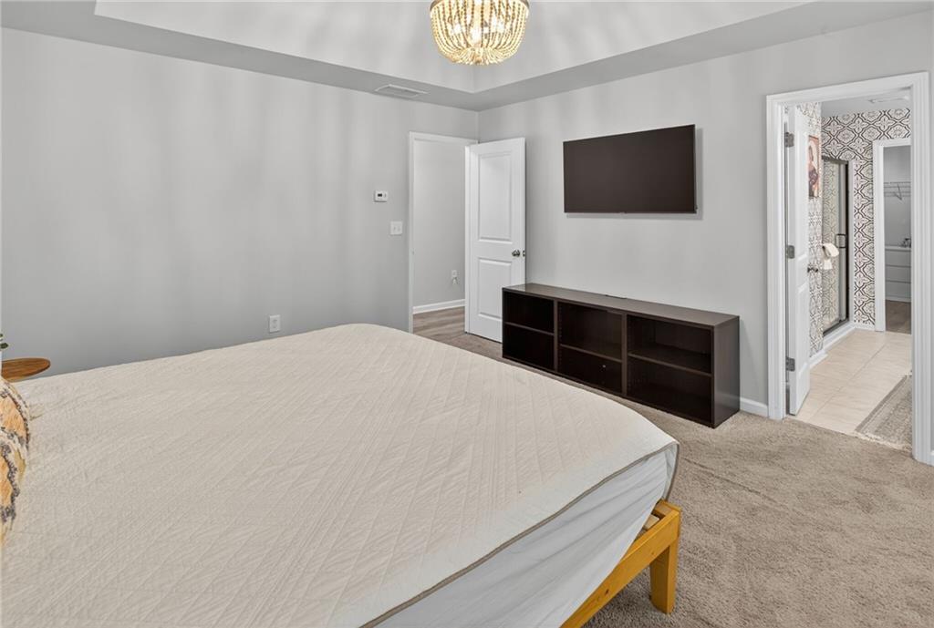 3333 Cascade Parc Boulevard Southwest Atlanta, GA 30311 - Photo 18 of 21 a bedroom with a bed and a flat screen tv