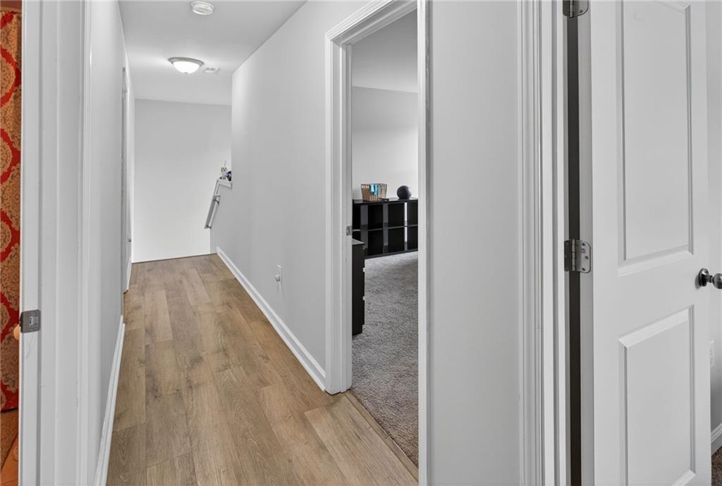 3333 Cascade Parc Boulevard Southwest Atlanta, GA 30311 - Photo 19 of 21 a view of a hallway with wooden floor and staircase