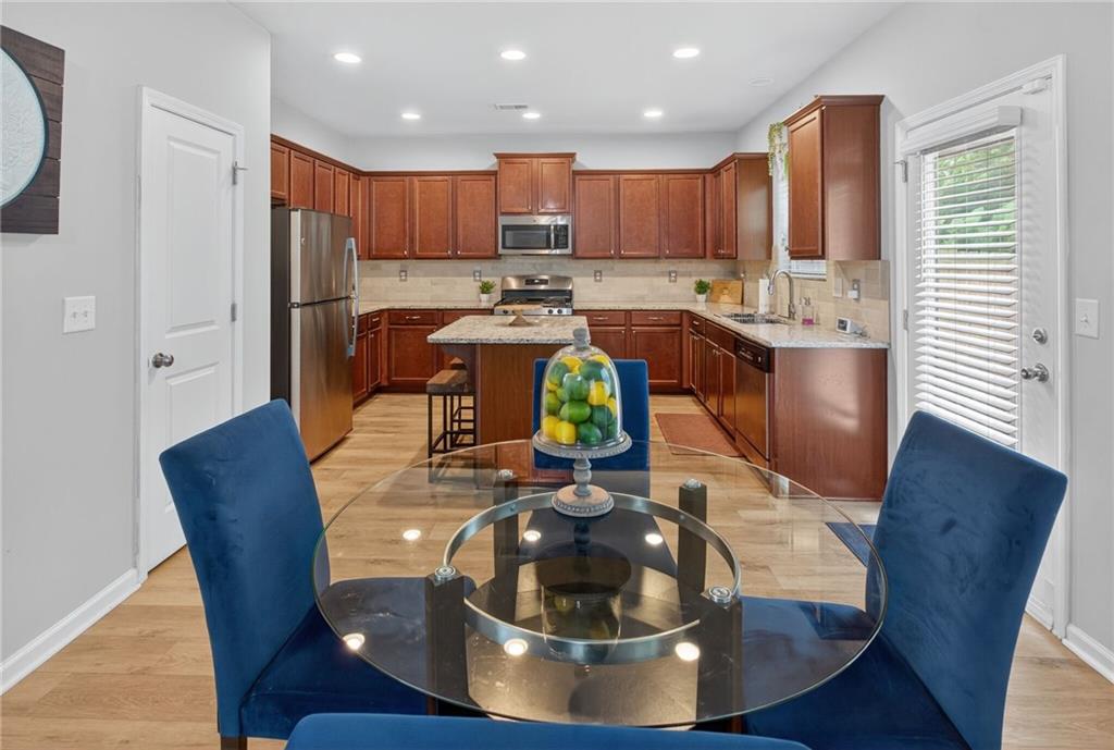 3333 Cascade Parc Boulevard Southwest Atlanta, GA 30311 - Photo 5 of 21 a kitchen with stainless steel appliances wooden floors wooden cabinets and a refrigerator