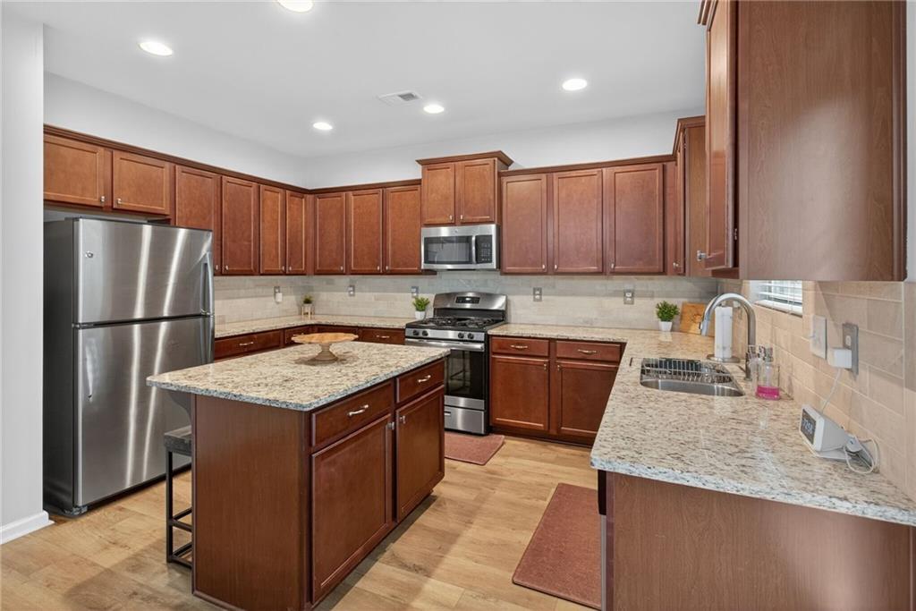 3333 Cascade Parc Boulevard Southwest Atlanta, GA 30311 - Photo 6 of 21 a kitchen with stainless steel appliances granite countertop a refrigerator stove sink and cabinets