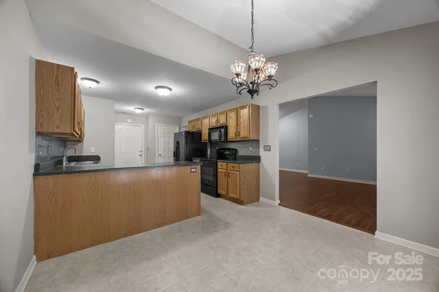 a view of a kitchen with a sink cabinets and stainless steel appliances