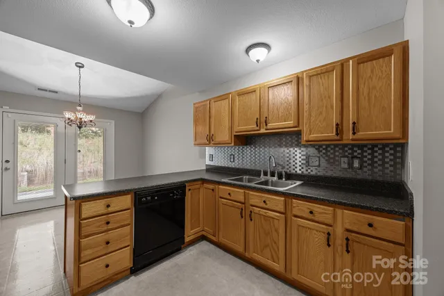 a kitchen with granite countertop cabinets a sink and dishwasher