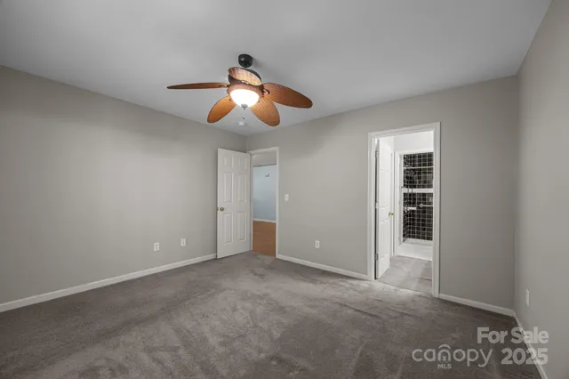 an empty room with closet and windows