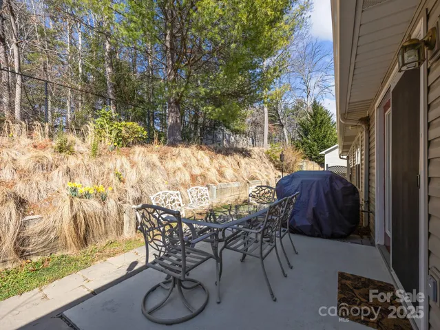 a view of patio with table and chairs and potted plants