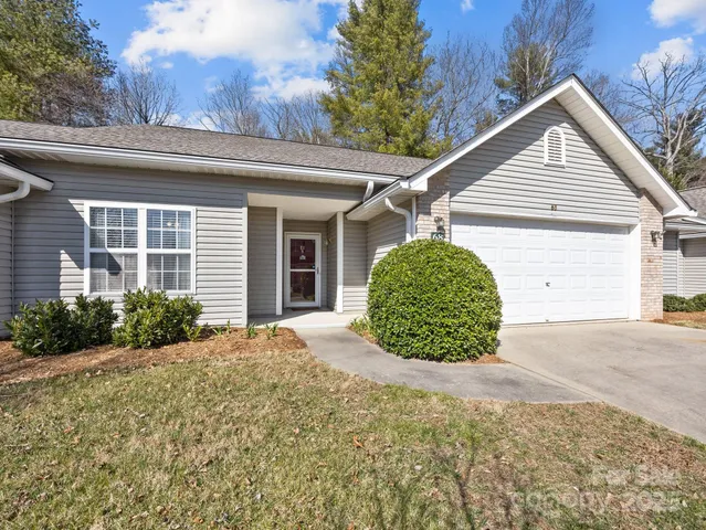 a view of a house with a small yard and plants