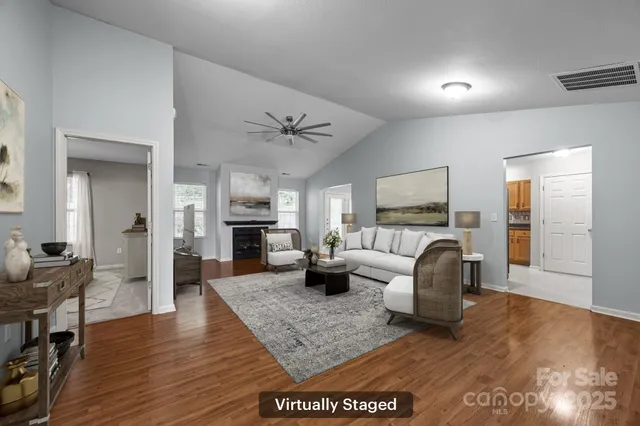 a living room with furniture wooden floor and a fireplace