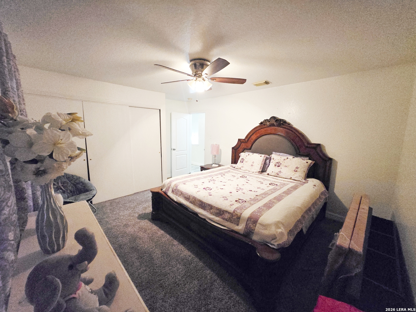 6606 Highland Grass Converse, TX 78109 - Photo 13 of 27 a bedroom with a bed and a chandelier