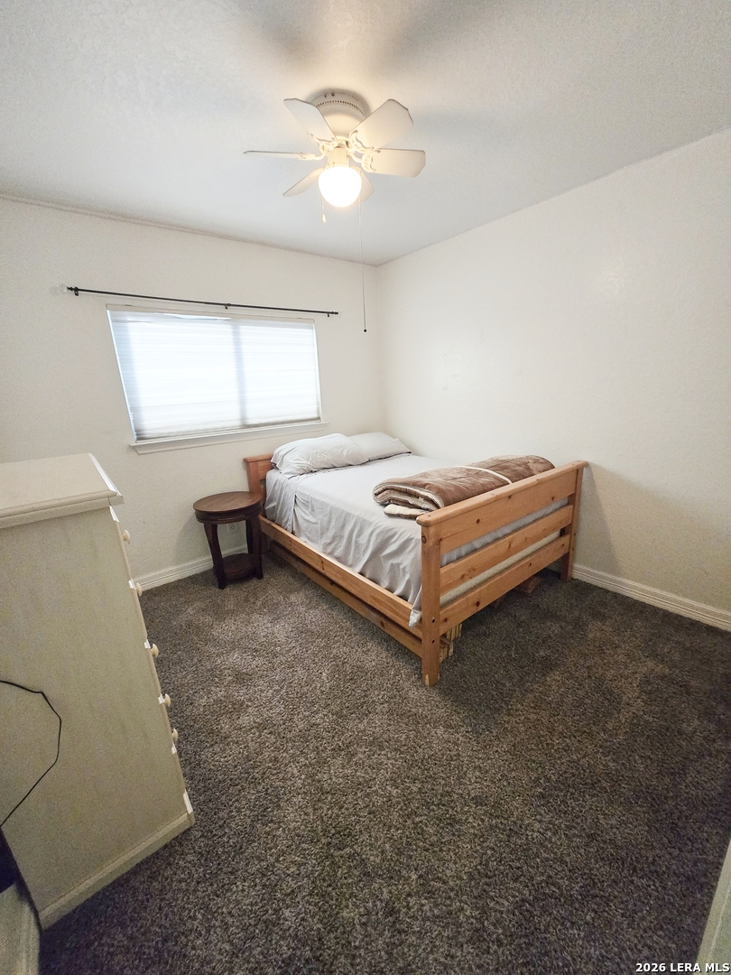 6606 Highland Grass Converse, TX 78109 - Photo 15 of 27 a spacious bedroom with a bed and window