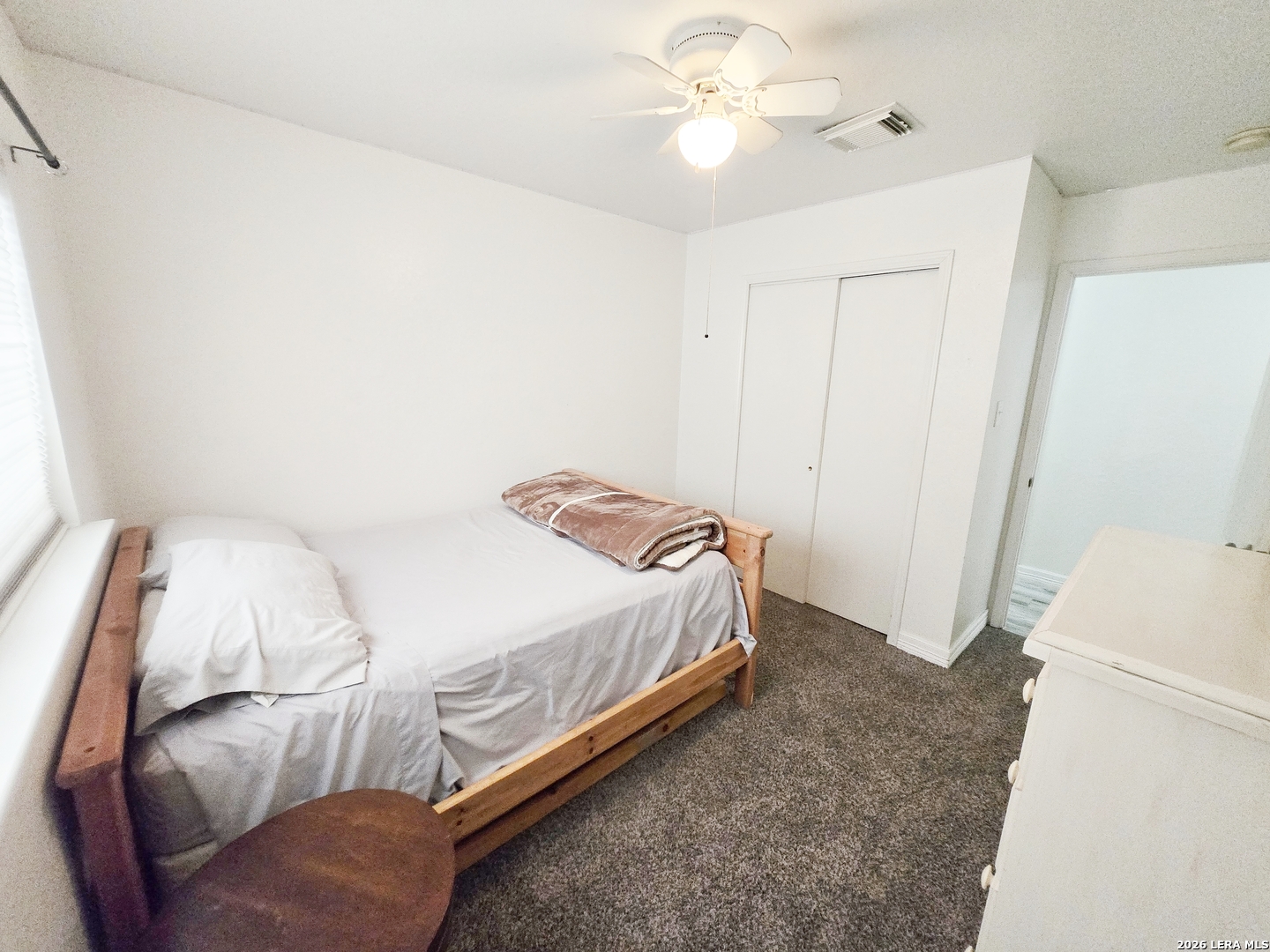 6606 Highland Grass Converse, TX 78109 - Photo 16 of 27 a bedroom with a bed and a chandelier