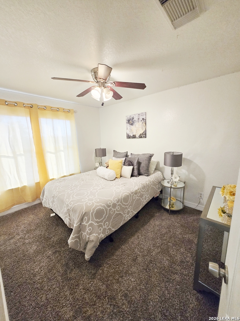 6606 Highland Grass Converse, TX 78109 - Photo 18 of 27 a spacious bedroom with a bed and a window