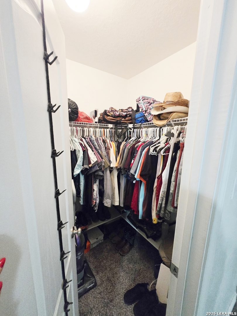 6606 Highland Grass Converse, TX 78109 - Photo 21 of 27 a view of walk in closet with clothes and shoes
