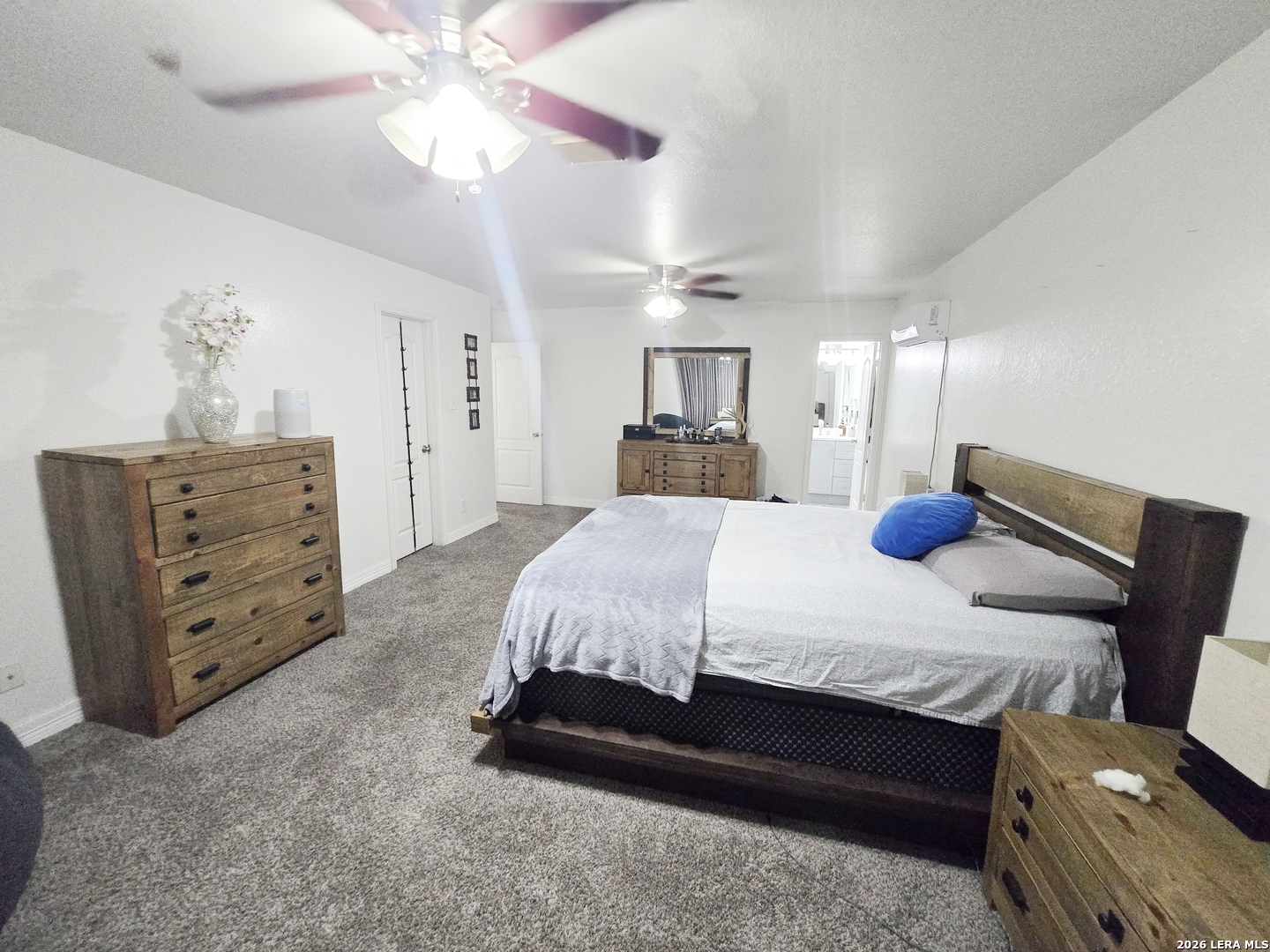 6606 Highland Grass Converse, TX 78109 - Photo 22 of 27 a bedroom with a bed and ceiling cabinets