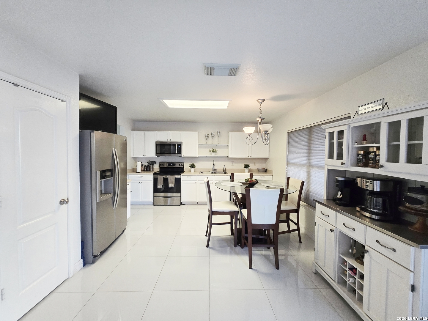 6606 Highland Grass Converse, TX 78109 - Photo 7 of 27 a kitchen with stainless steel appliances kitchen island granite countertop a refrigerator and cabinets