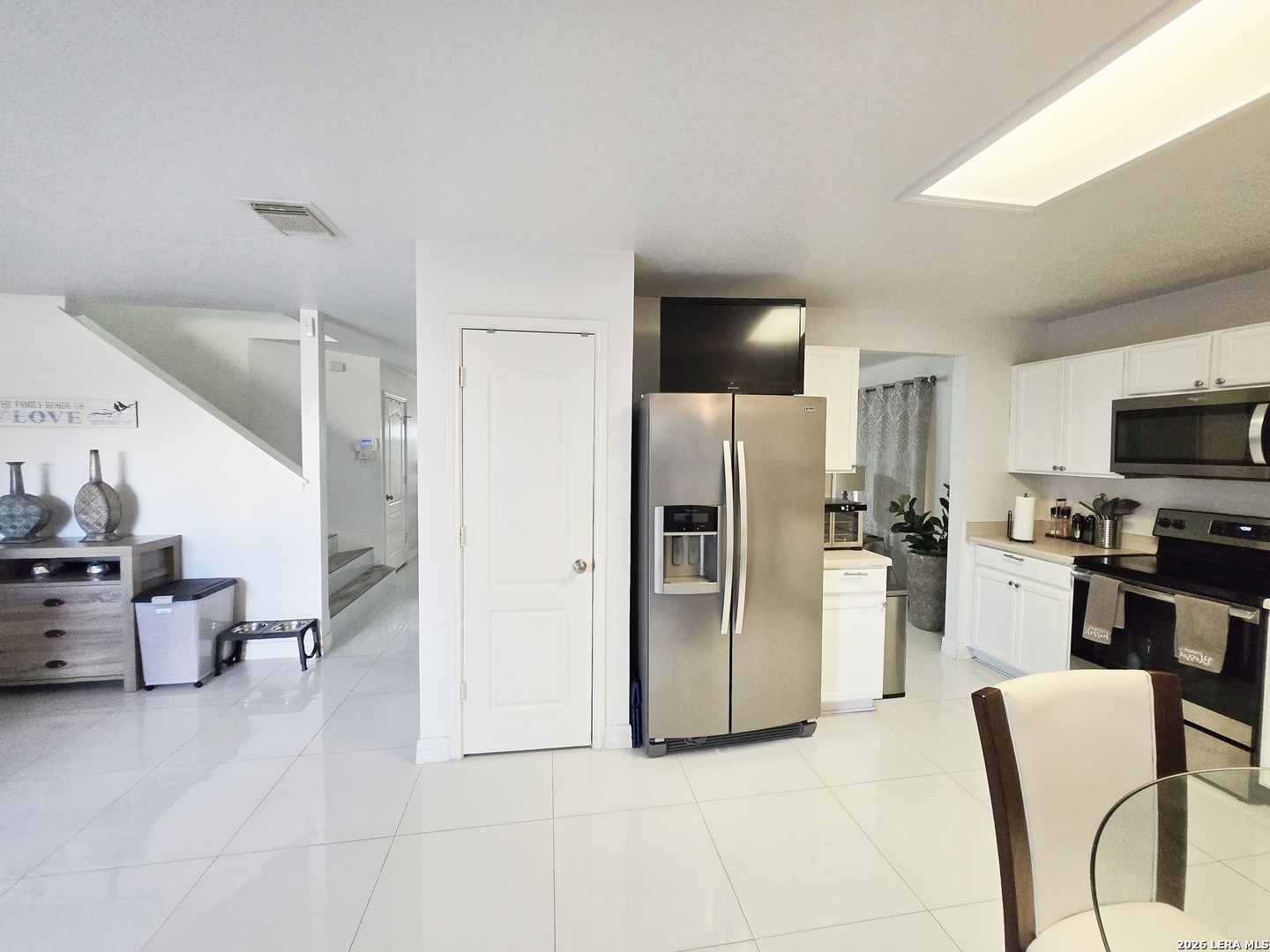 6606 Highland Grass Converse, TX 78109 - Photo 8 of 27 a kitchen with stainless steel appliances kitchen island granite countertop lots of white furniture