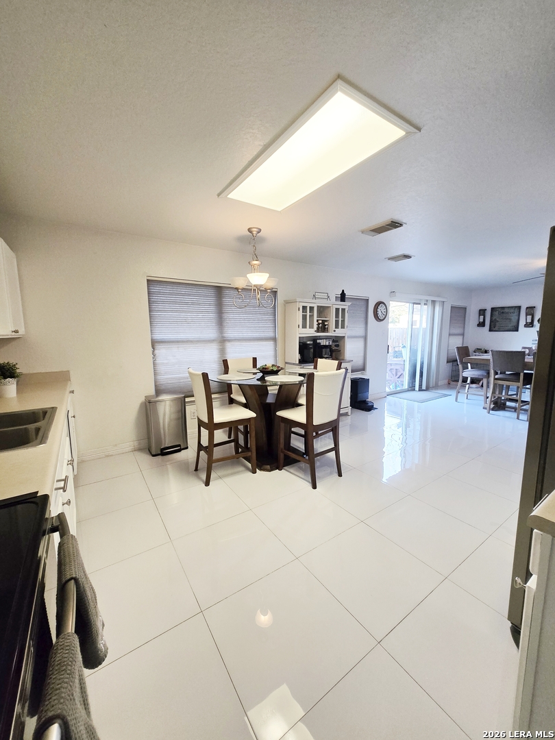 6606 Highland Grass Converse, TX 78109 - Photo 9 of 27 a living room with furniture and a flat screen tv