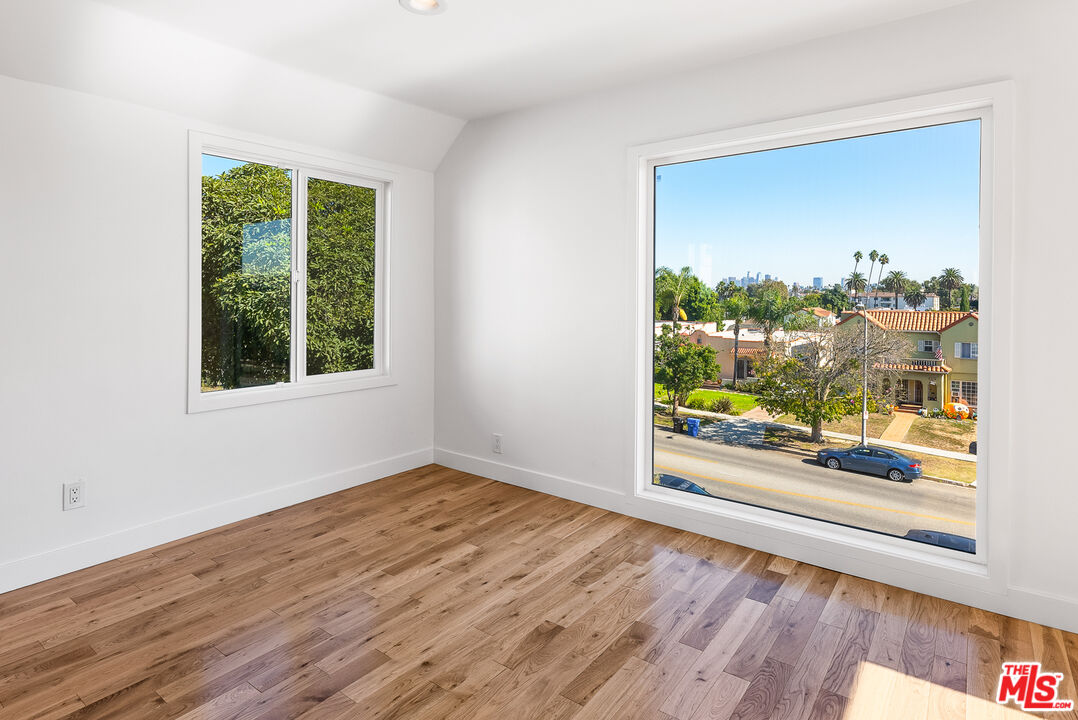 1253 South Rimpau Boulevard Los Angeles, CA 90019 - Photo 25 of 71 a view of a big room with wooden floor and windows