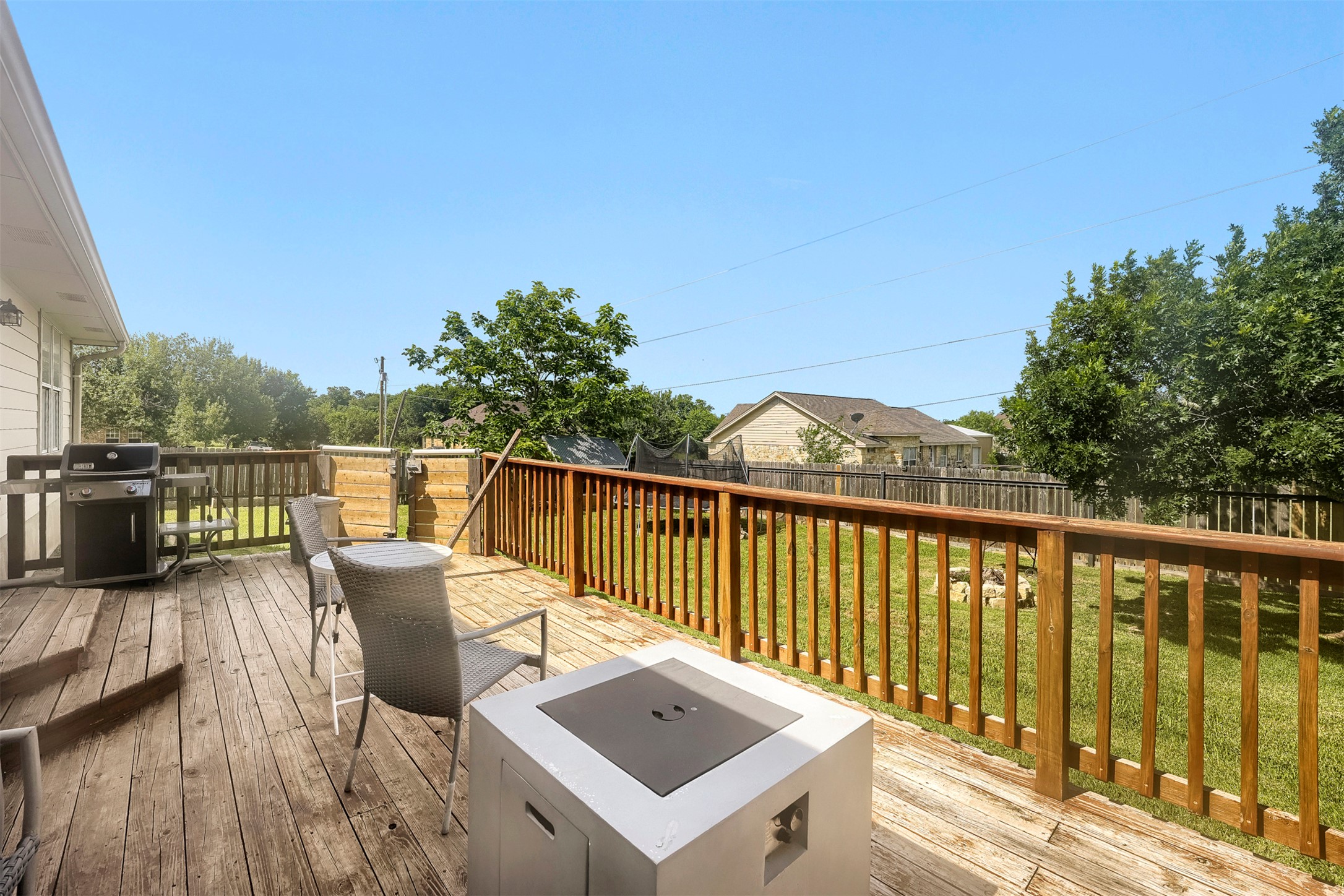 1105 2nd Street Jarrell, TX 76537 - Photo 22 of 27 A spacious wooden deck provides ample outdoor living space, perfect for entertaining.