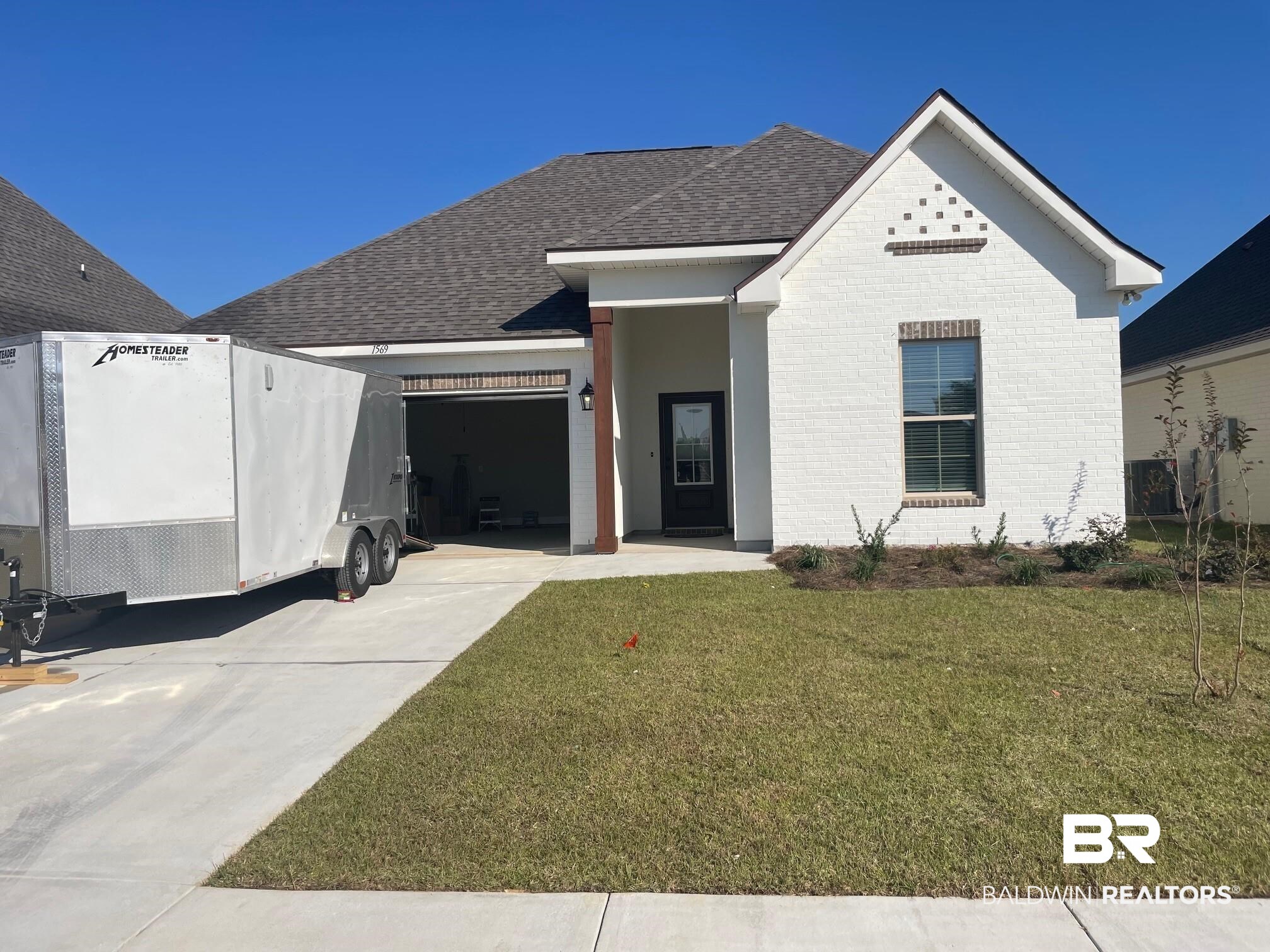 1569 Fenton Circle Foley, AL 36535 - Photo 1 of 3 View of front of home with a garage and a front lawn