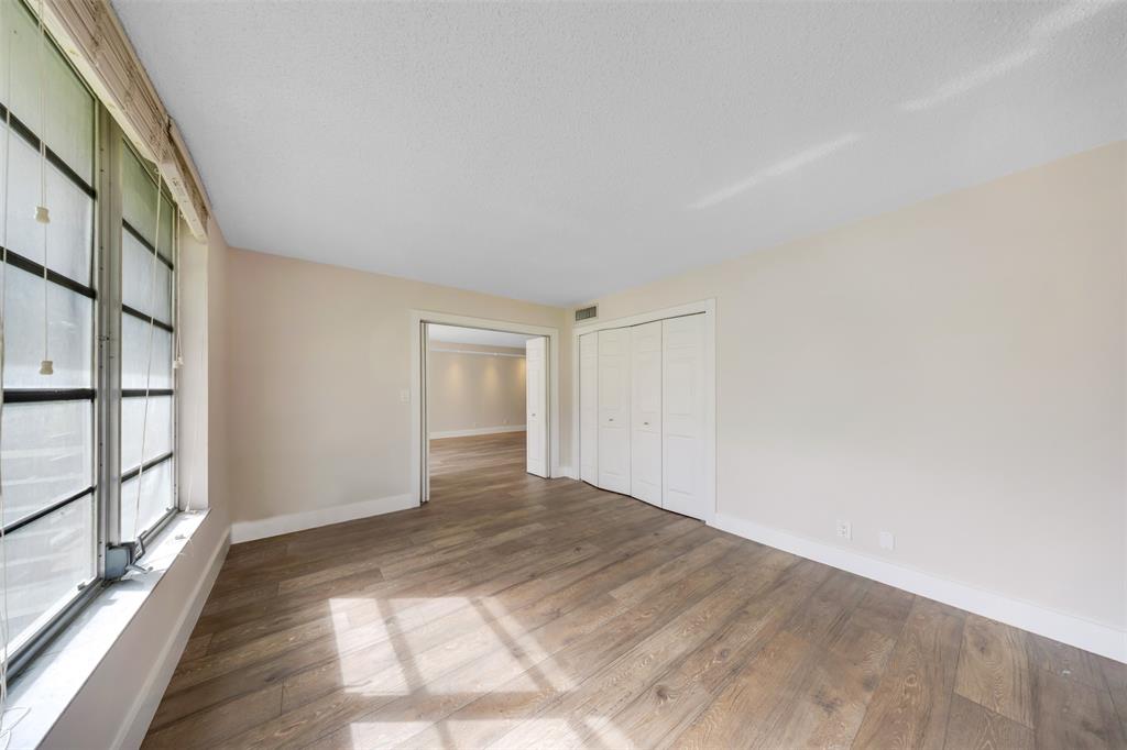 800 East Cypress Lane, Unit 206 Pompano Beach, FL 33069 - Photo 18 of 33 a view of empty room with wooden floor and fan