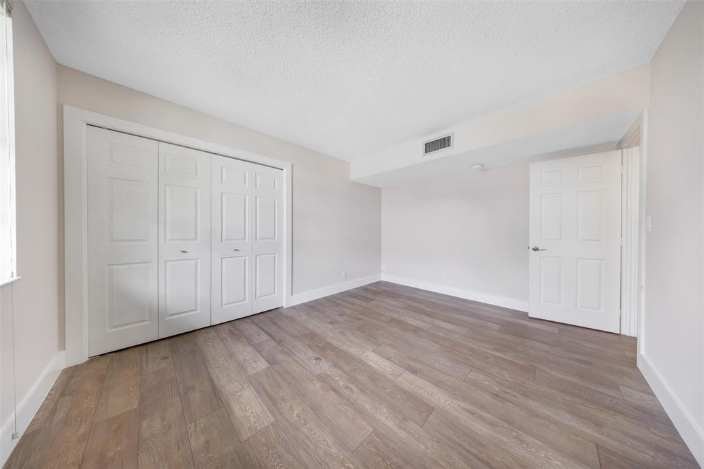 800 East Cypress Lane, Unit 206 Pompano Beach, FL 33069 - Photo 21 of 33 a view of an empty room with wooden floor