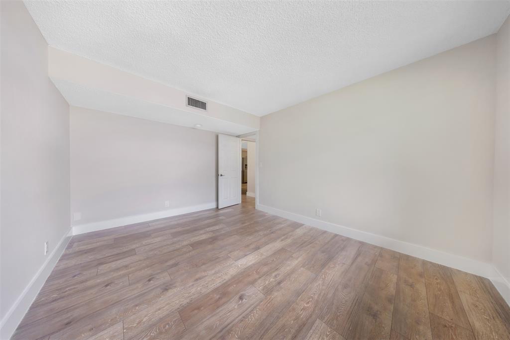 800 East Cypress Lane, Unit 206 Pompano Beach, FL 33069 - Photo 22 of 33 a view of an empty room with wooden floor