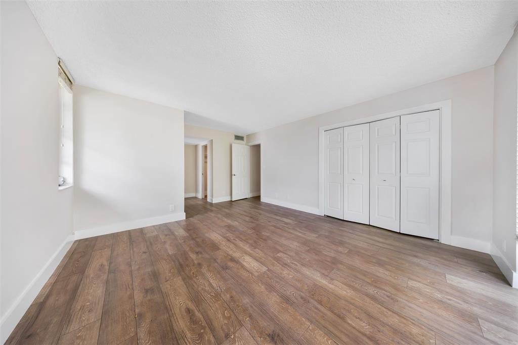 800 East Cypress Lane, Unit 206 Pompano Beach, FL 33069 - Photo 25 of 33 a view of an empty room with wooden floor