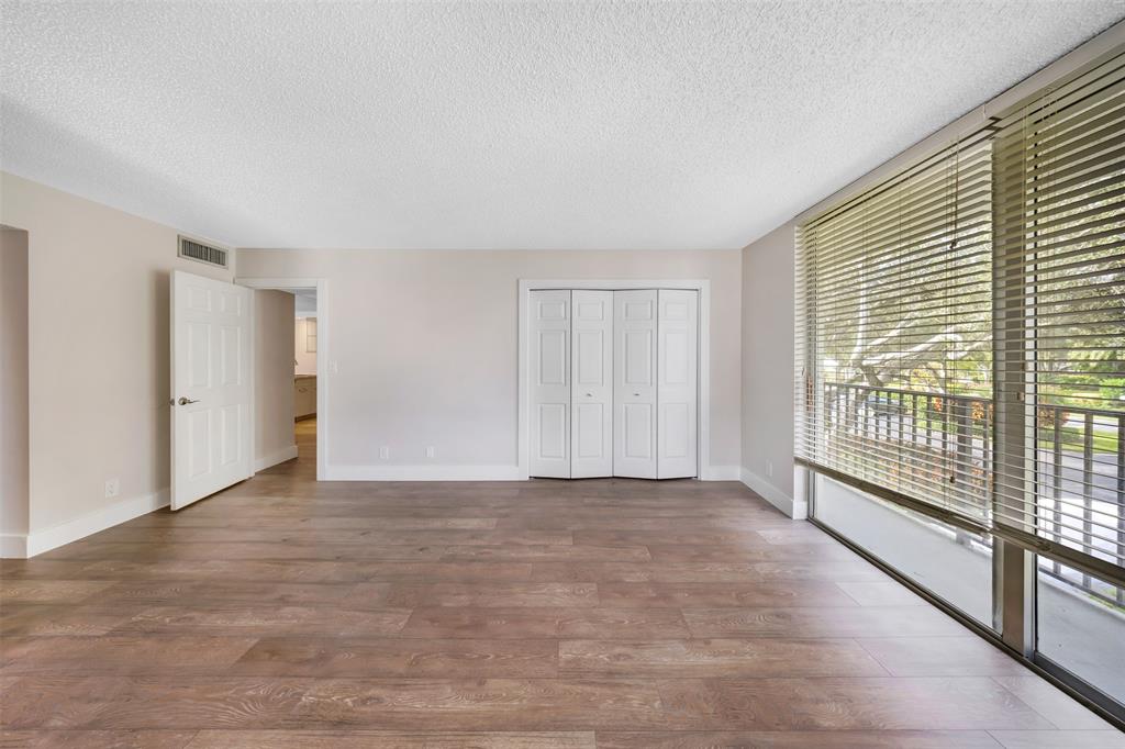 800 East Cypress Lane, Unit 206 Pompano Beach, FL 33069 - Photo 26 of 33 a view of a big room with windows and brick walls