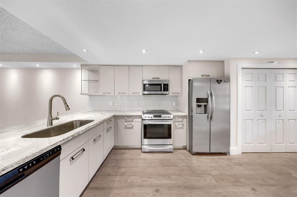 800 East Cypress Lane, Unit 206 Pompano Beach, FL 33069 - Photo 3 of 33 a kitchen with stainless steel appliances granite countertop a sink and refrigerator