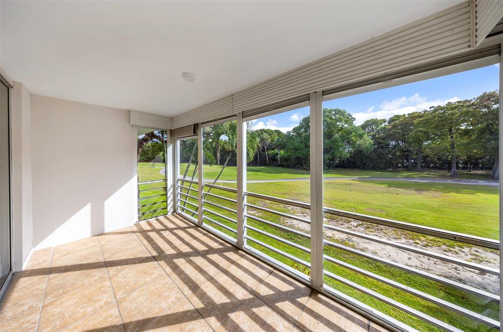 800 East Cypress Lane, Unit 206 Pompano Beach, FL 33069 - Photo 31 of 33 a view of swimming pool with deck and large windows