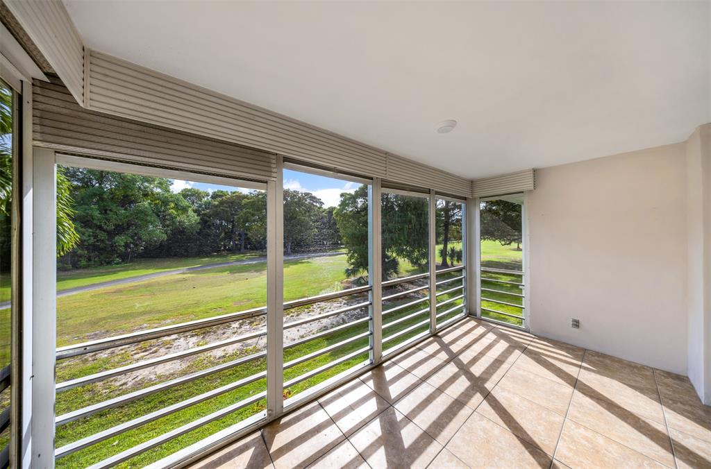 800 East Cypress Lane, Unit 206 Pompano Beach, FL 33069 - Photo 32 of 33 a view of a room with wooden floor and a bed