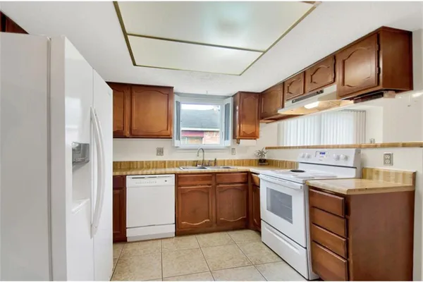 a kitchen with a sink cabinets and stainless steel appliances