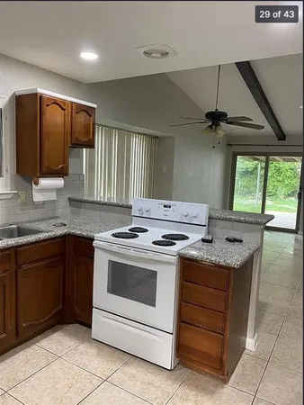 a kitchen with a stove sink and cabinets