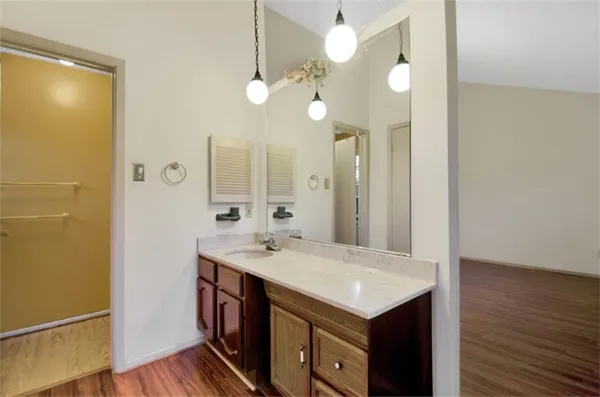 a kitchen with a sink and a mirror