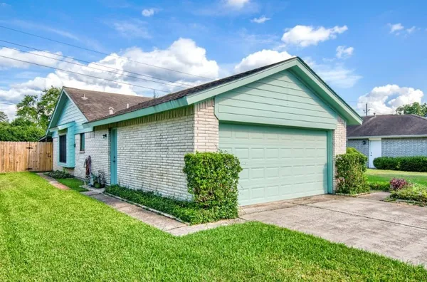 a front view of house with backyard and green space