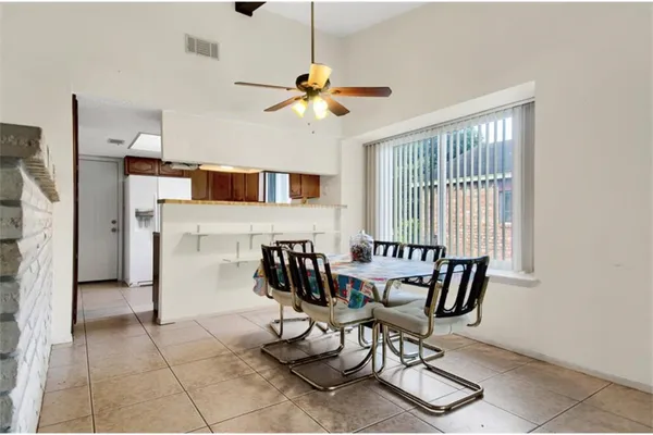 a dining room with furniture and window
