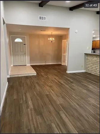 a view of a room with wooden floor