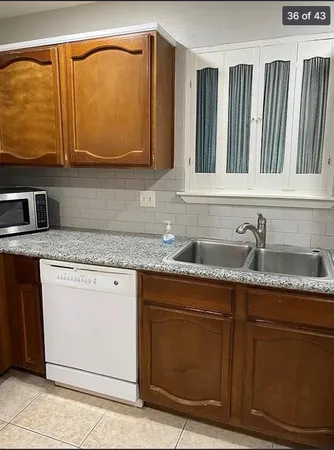 a kitchen with granite countertop a sink and a stove