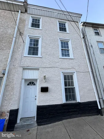 a front view of a house with large windows