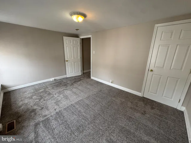 an empty room with closet area