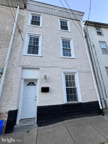 a front view of a house with large windows